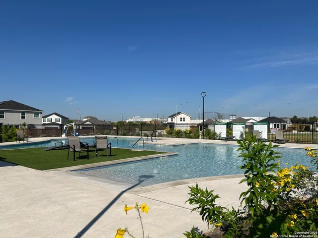 a view of a swimming pool and a yard