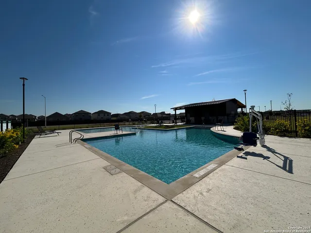a view of swimming pool with outdoor seating