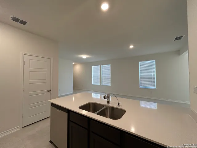 a kitchen with a sink and cabinets