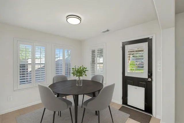 a view of a dining room with furniture and window