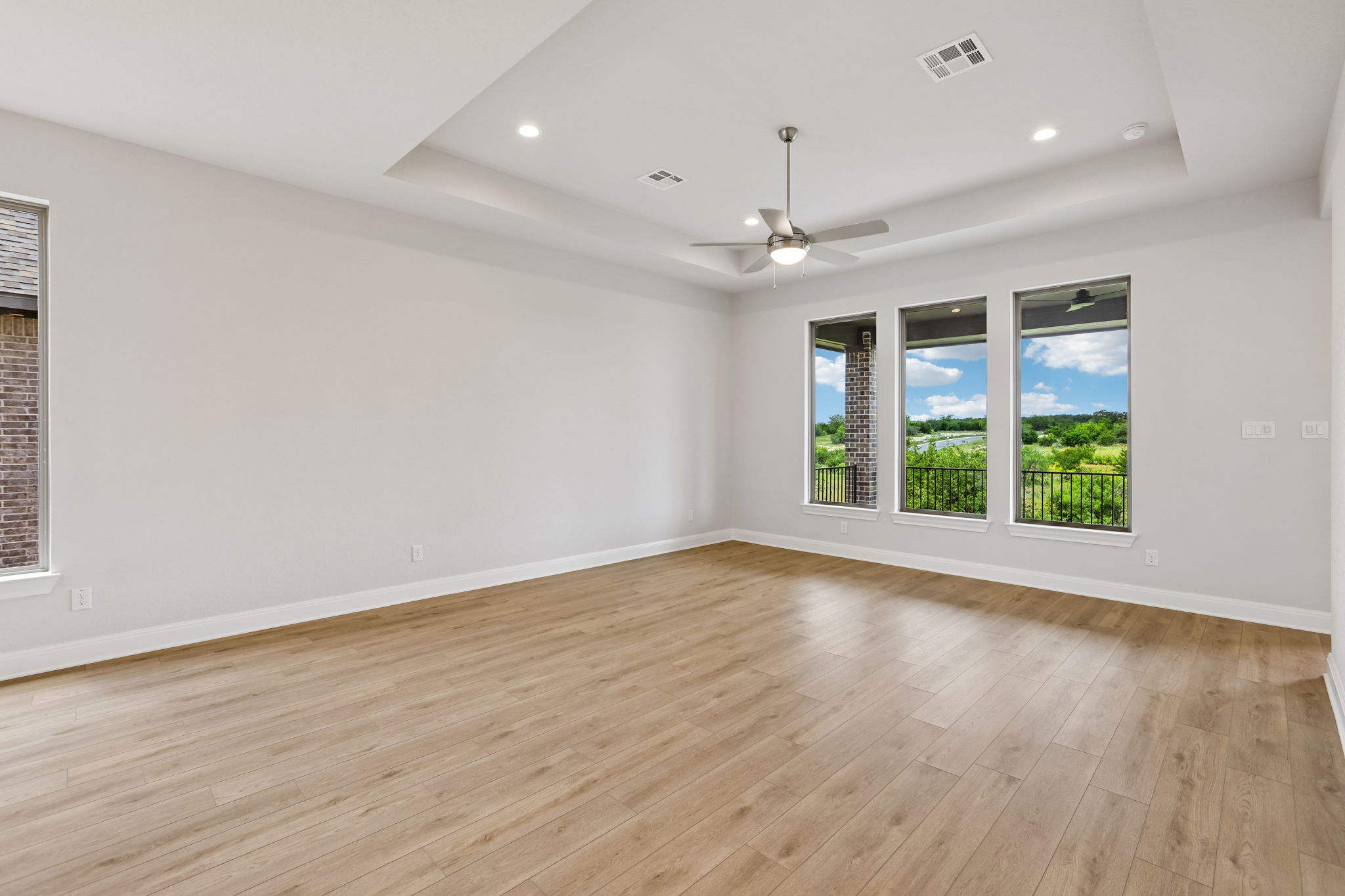 214 Prickly Poppy Loop Kyle, TX 78640 - Photo 11 of 38 an empty room with wooden floor and windows