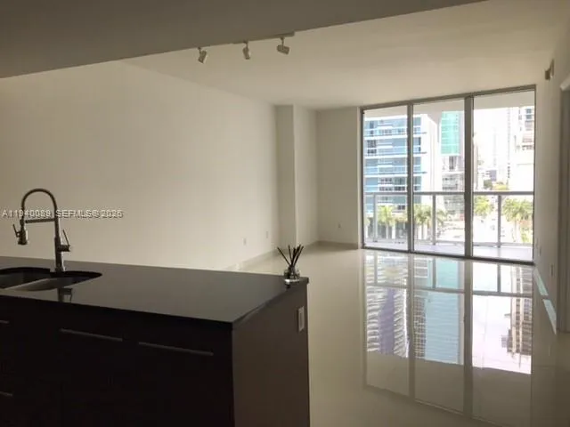 a room with a window and ceiling fan