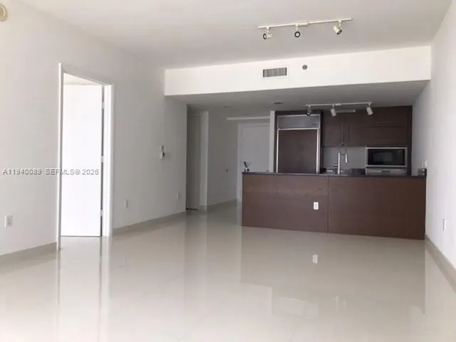 a kitchen with a refrigerator and cabinets