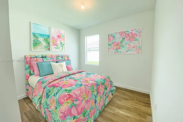 a bedroom with a bed and wooden floor