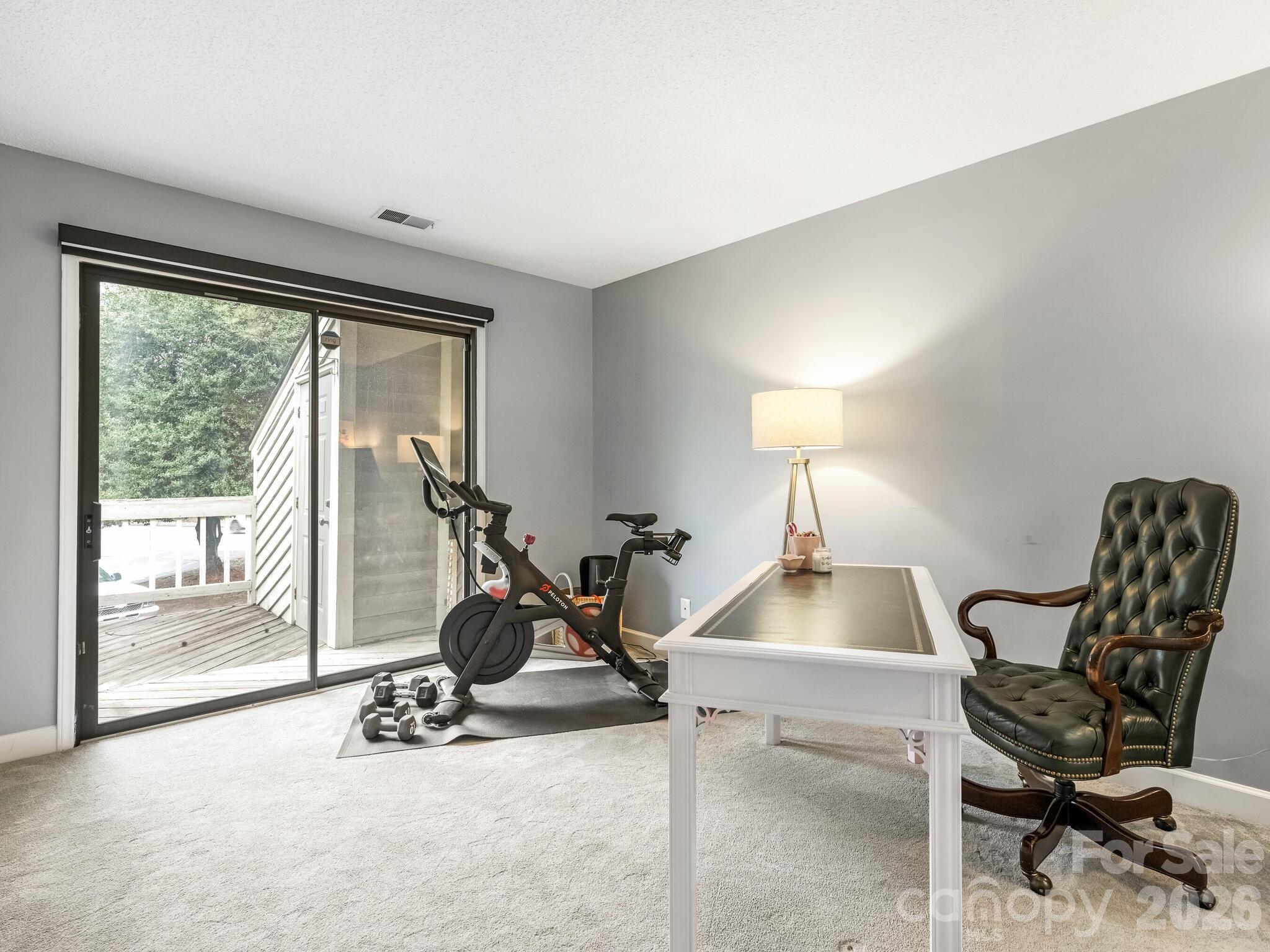 1612 Sharon Road West, Unit 68 Charlotte, NC 28210 - Photo 12 of 18 a room with gym equipment and a large window