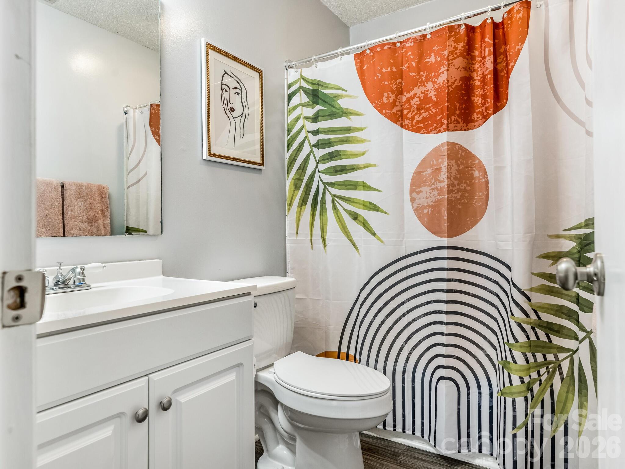 1612 Sharon Road West, Unit 68 Charlotte, NC 28210 - Photo 14 of 18 a bathroom with a sink a toilet and a mirror