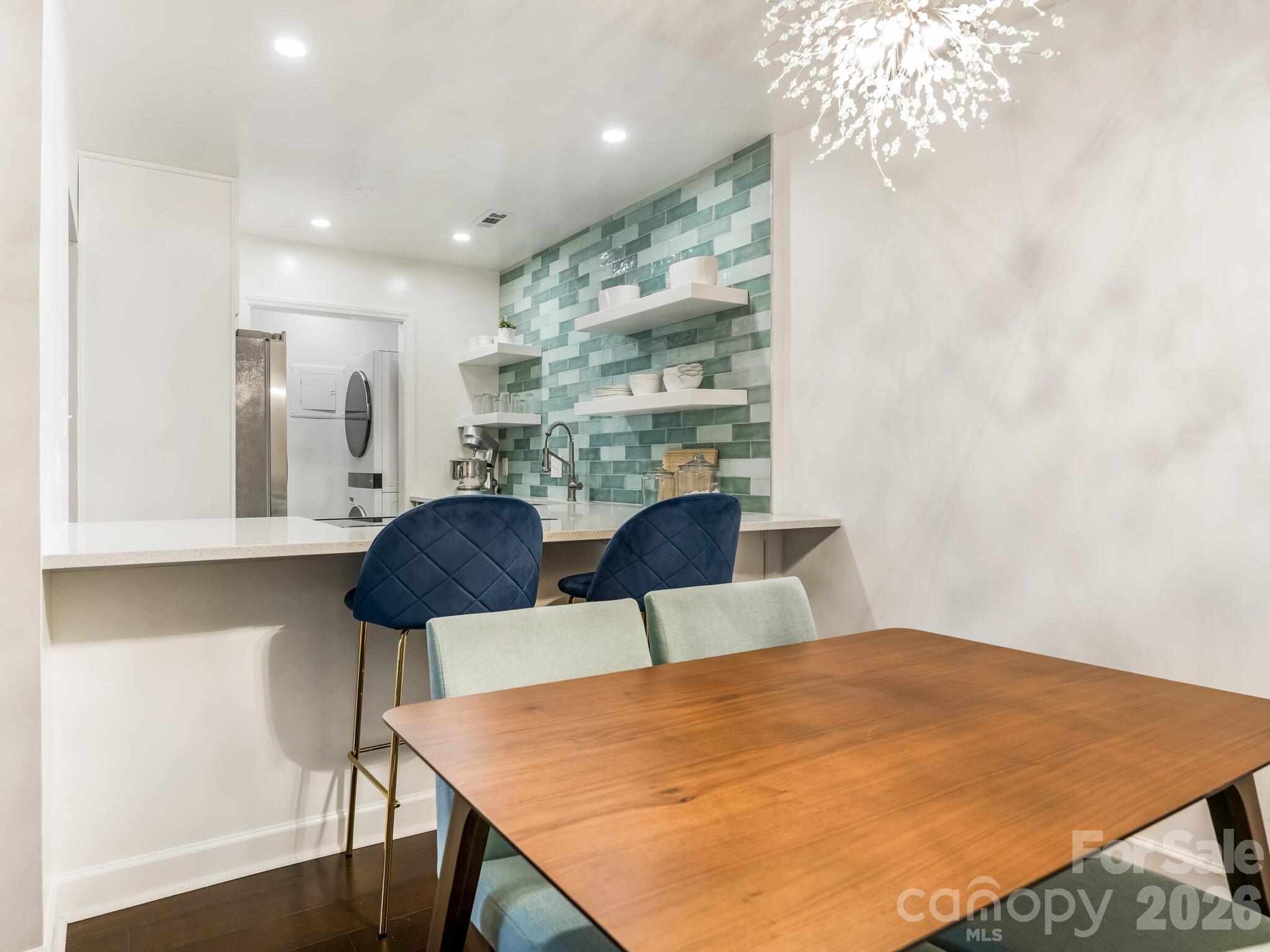1612 Sharon Road West, Unit 68 Charlotte, NC 28210 - Photo 6 of 18 a view of a dining room with furniture and wooden floor