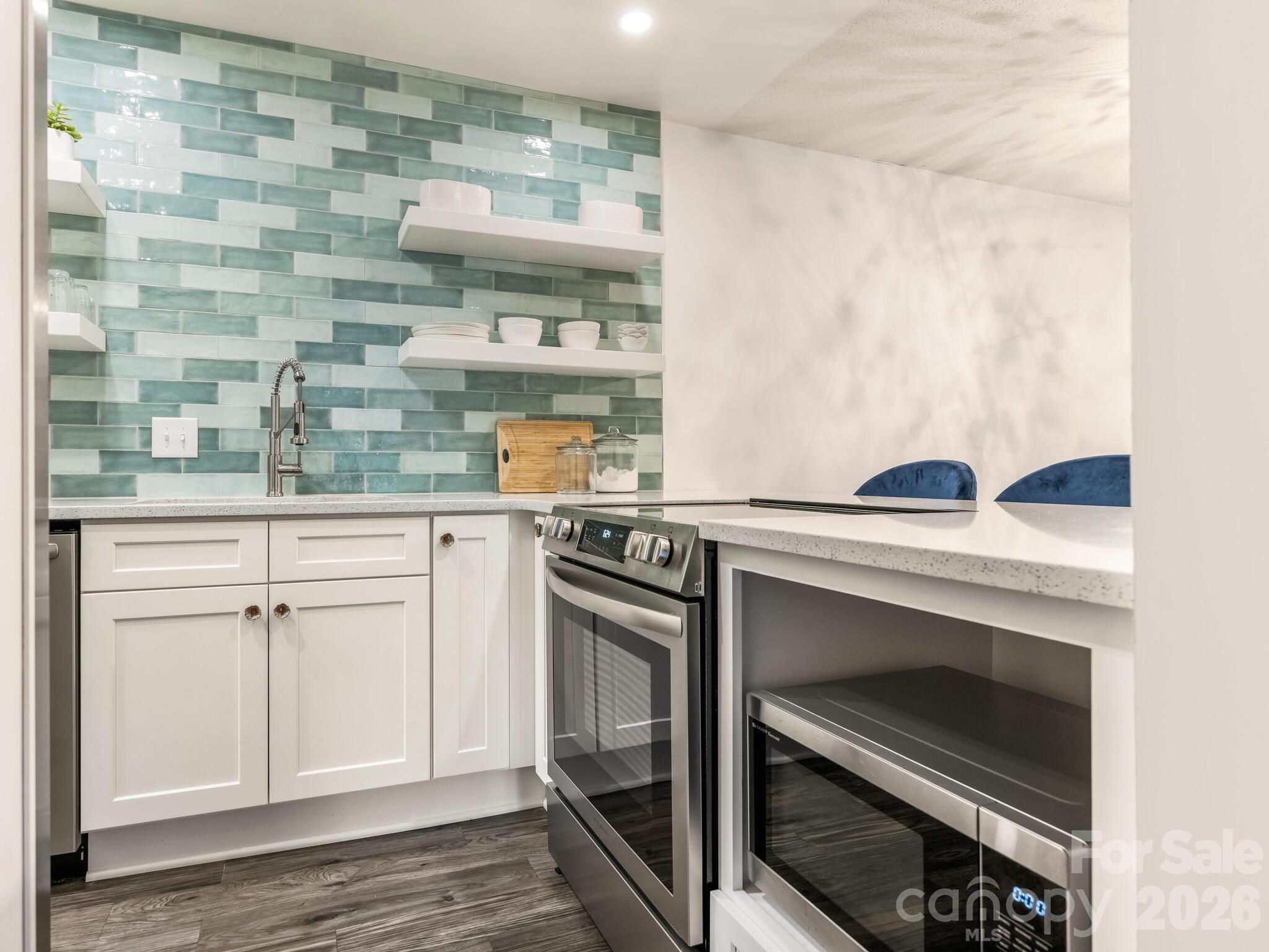 1612 Sharon Road West, Unit 68 Charlotte, NC 28210 - Photo 7 of 18 a kitchen with granite countertop a stove and a sink
