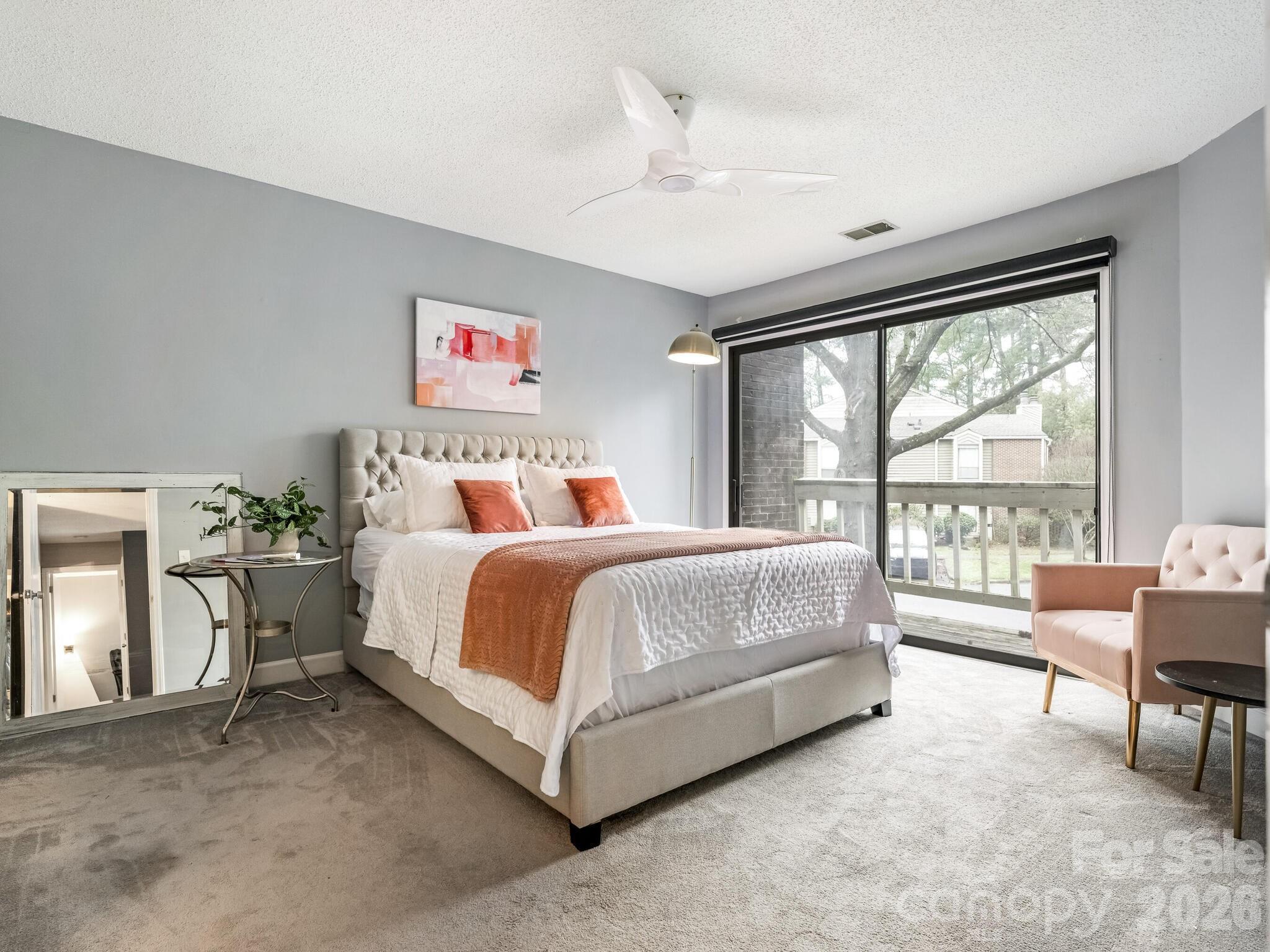 1612 Sharon Road West, Unit 68 Charlotte, NC 28210 - Photo 9 of 18 a spacious bedroom with a bed and glass window