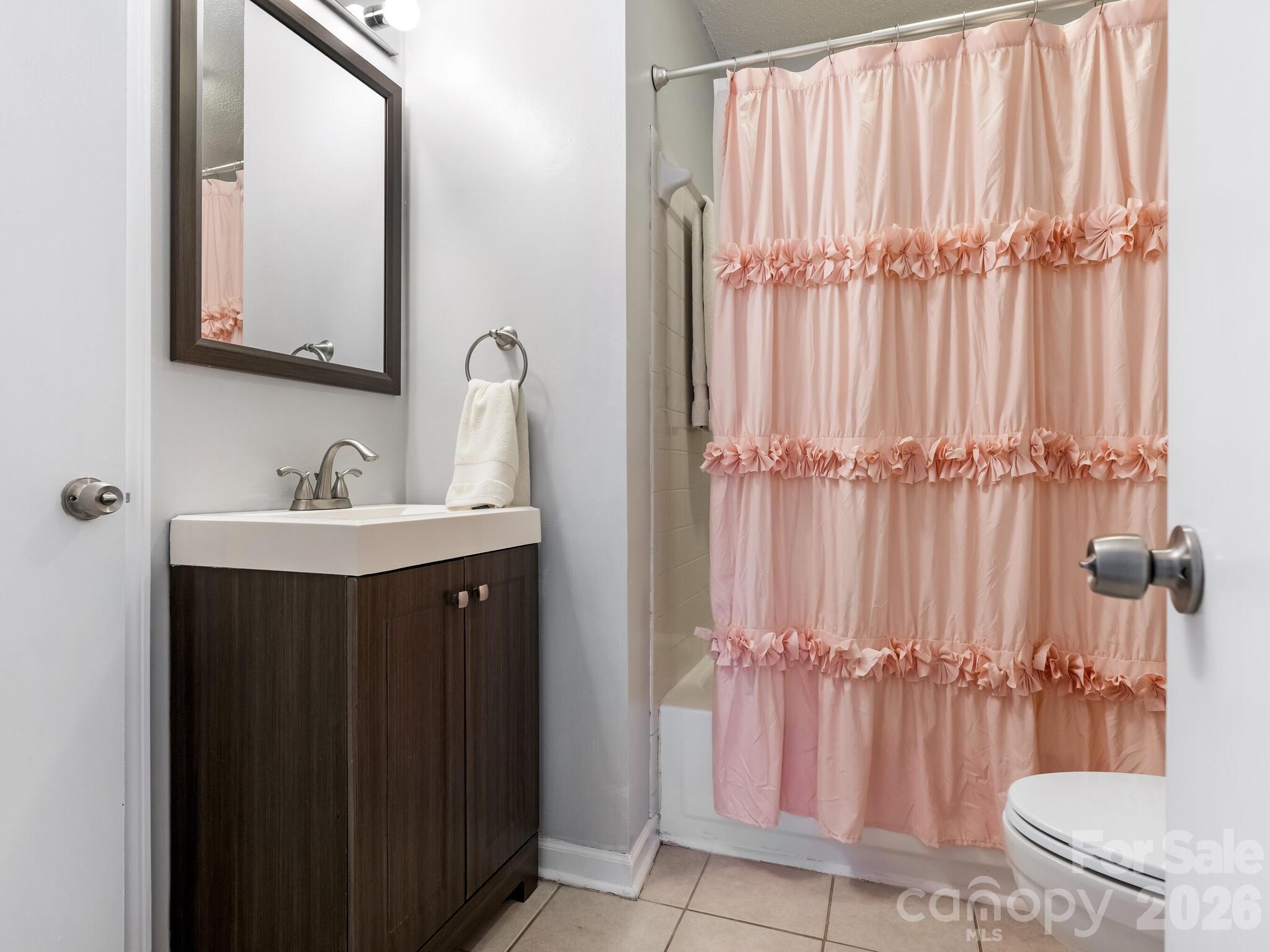 1612 Sharon Road West, Unit 68 Charlotte, NC 28210 - Photo 10 of 18 a bathroom with a sink a toilet and shower