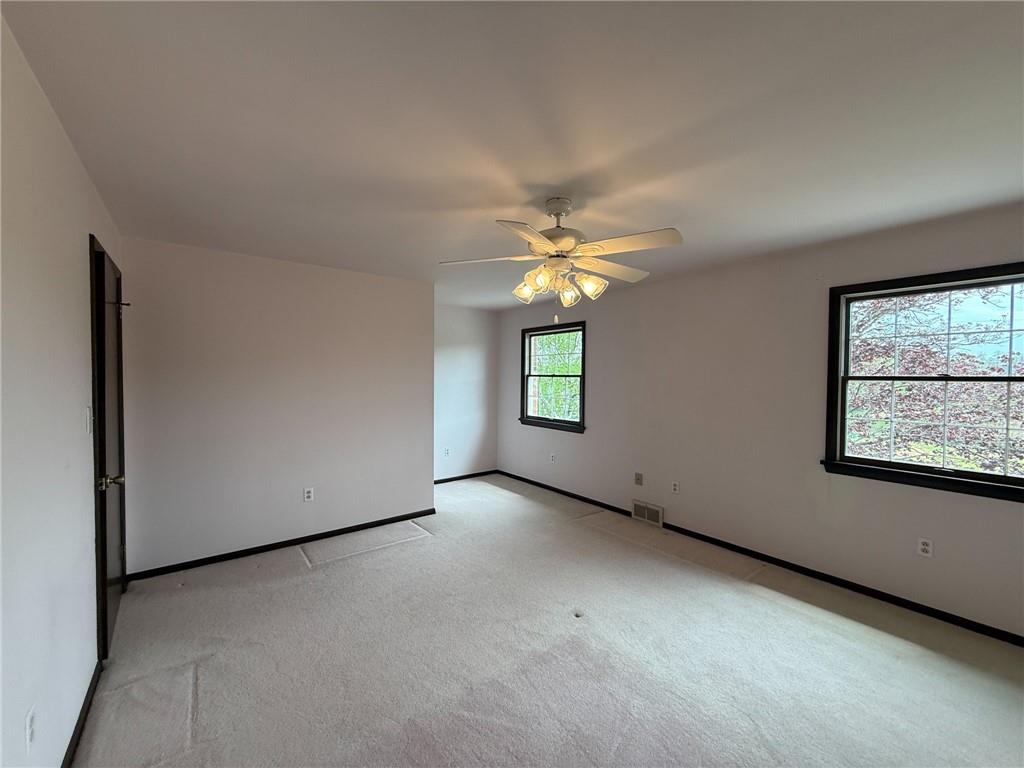 1194 Butler Road Worthington, PA 16262 - Photo 35 of 50 an empty room with windows and chandelier fan