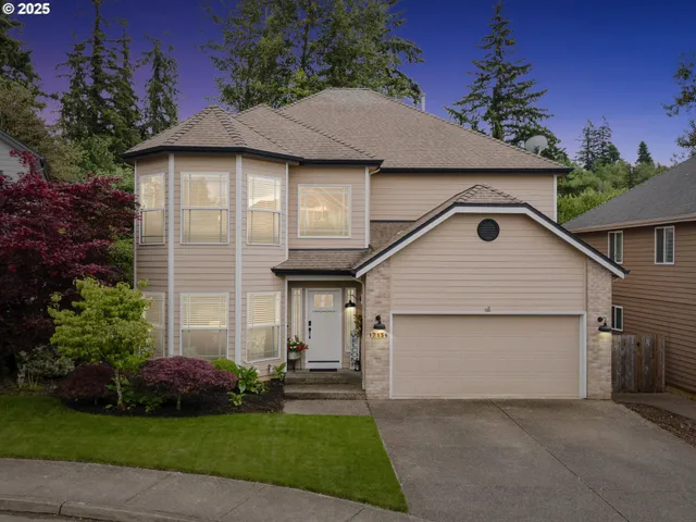 a front view of a house with a garden and plants