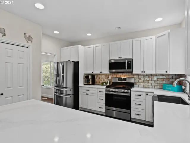 a kitchen with stainless steel appliances and cabinets