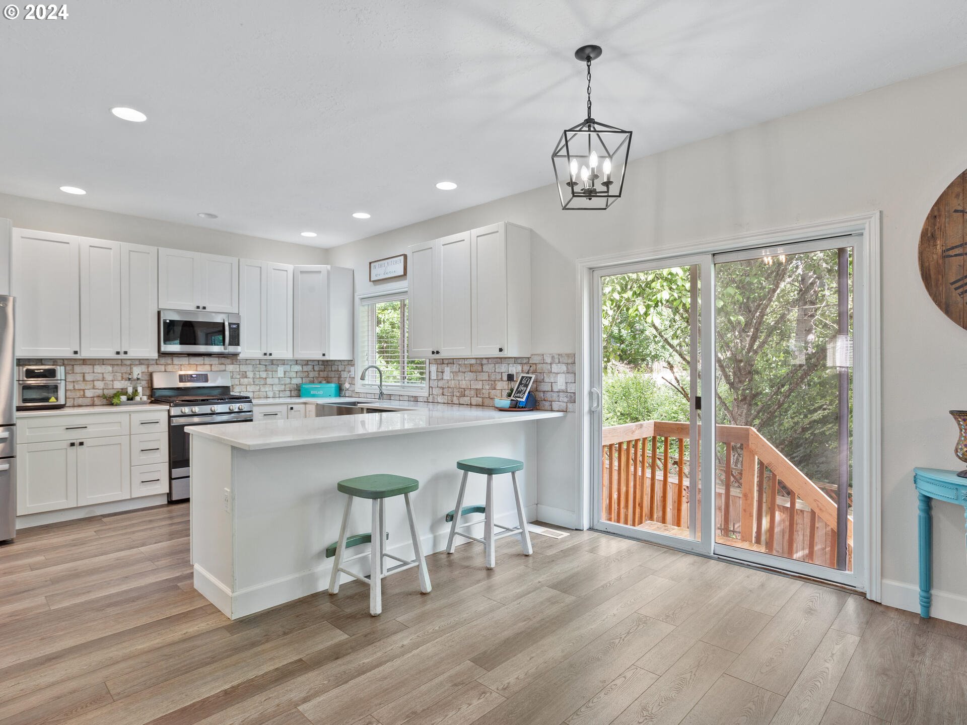 17156 Southeast Macanudo Street Damascus, OR 97089 - Photo 19 of 47 a kitchen with a table chairs stove and cabinets