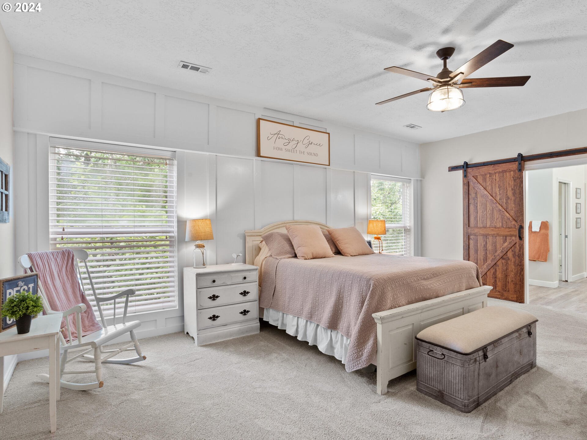 17156 Southeast Macanudo Street Damascus, OR 97089 - Photo 29 of 47 a spacious bedroom with a bed and a chandelier