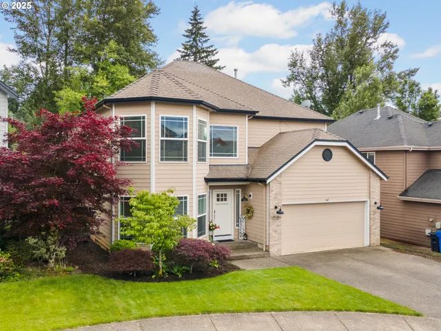 a front view of a house with a garden and plants
