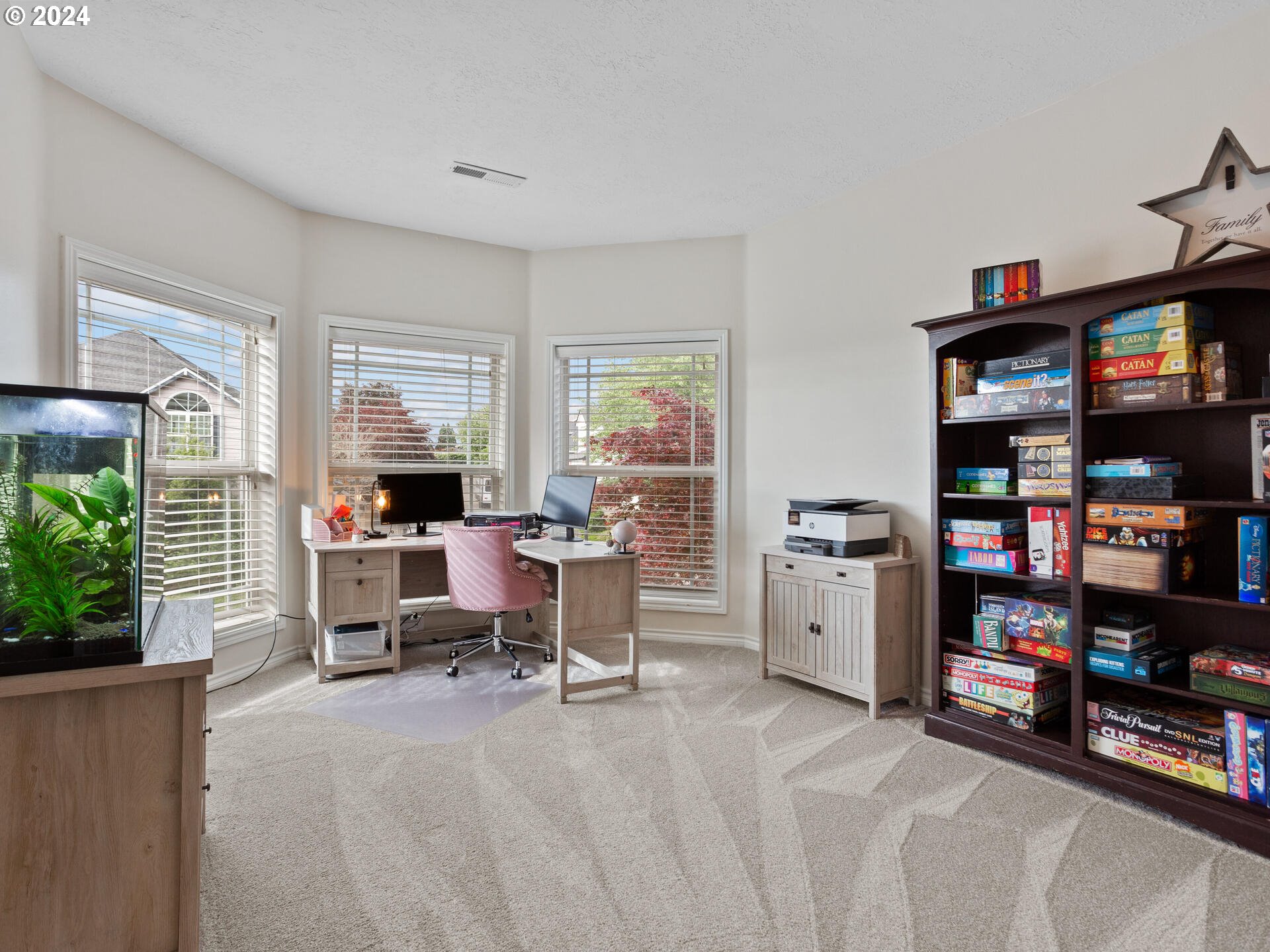 17156 Southeast Macanudo Street Damascus, OR 97089 - Photo 32 of 47 a view of a workspace with furniture and a bookshelf