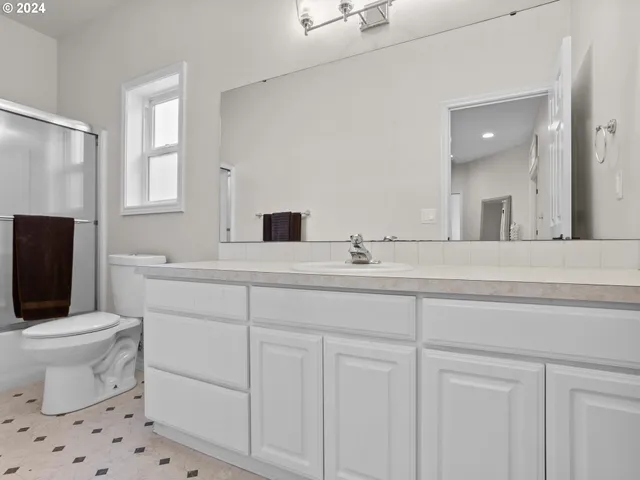 a bathroom with a sink toilet and mirror