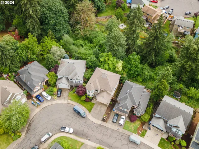 an aerial view of a house with swimming pool and garden