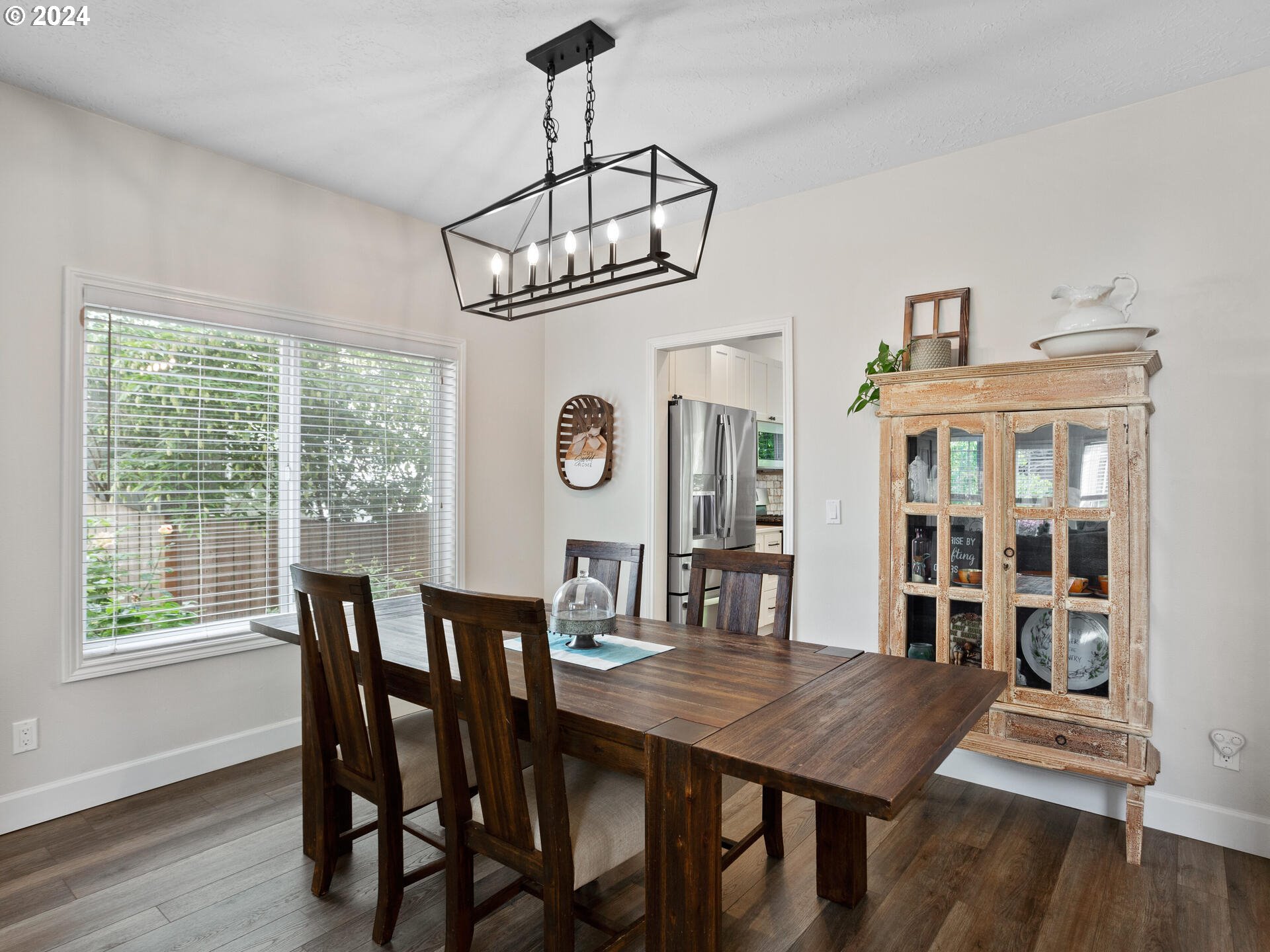 17156 Southeast Macanudo Street Damascus, OR 97089 - Photo 10 of 47 a view of a dining room with furniture window and wooden floor