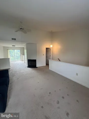 a view of an empty room with a fireplace