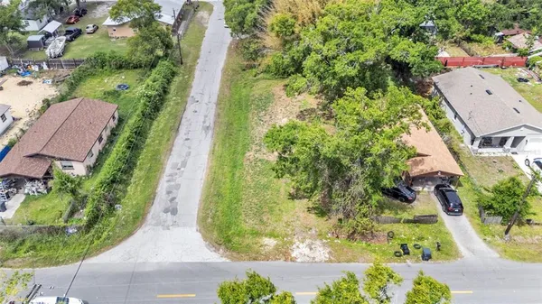 an aerial view of a residential houses with yard