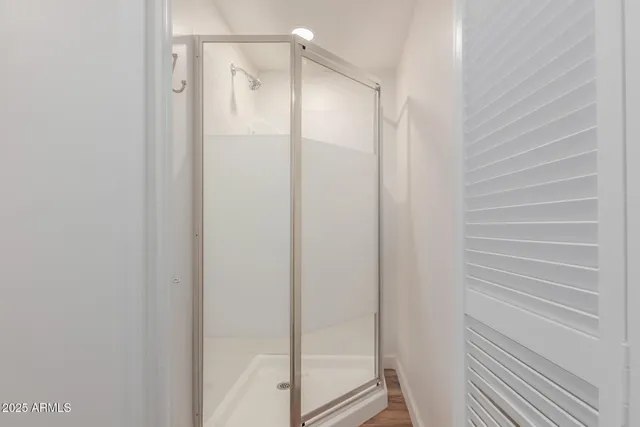 a bathroom with a glass shower door