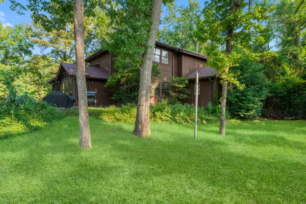 a view of an house with backyard space and garden