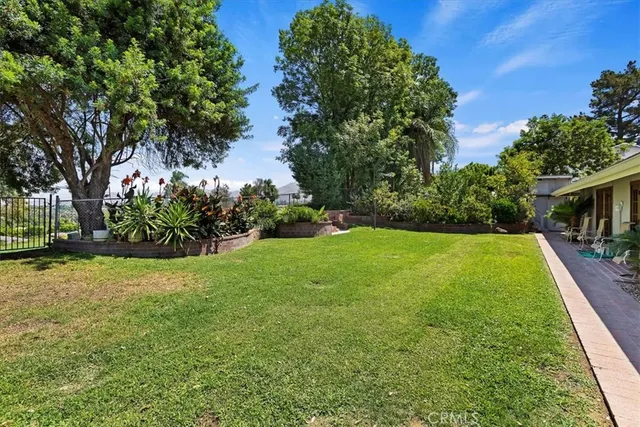 a view of yard with swimming pool and green space
