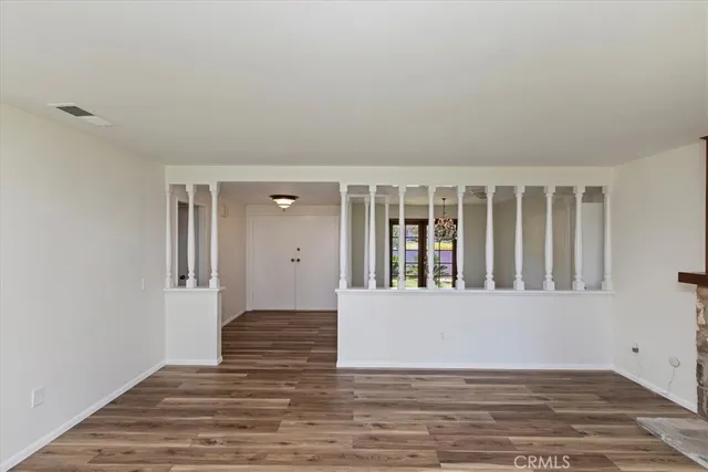 a view of wooden floor and a window in an empty room