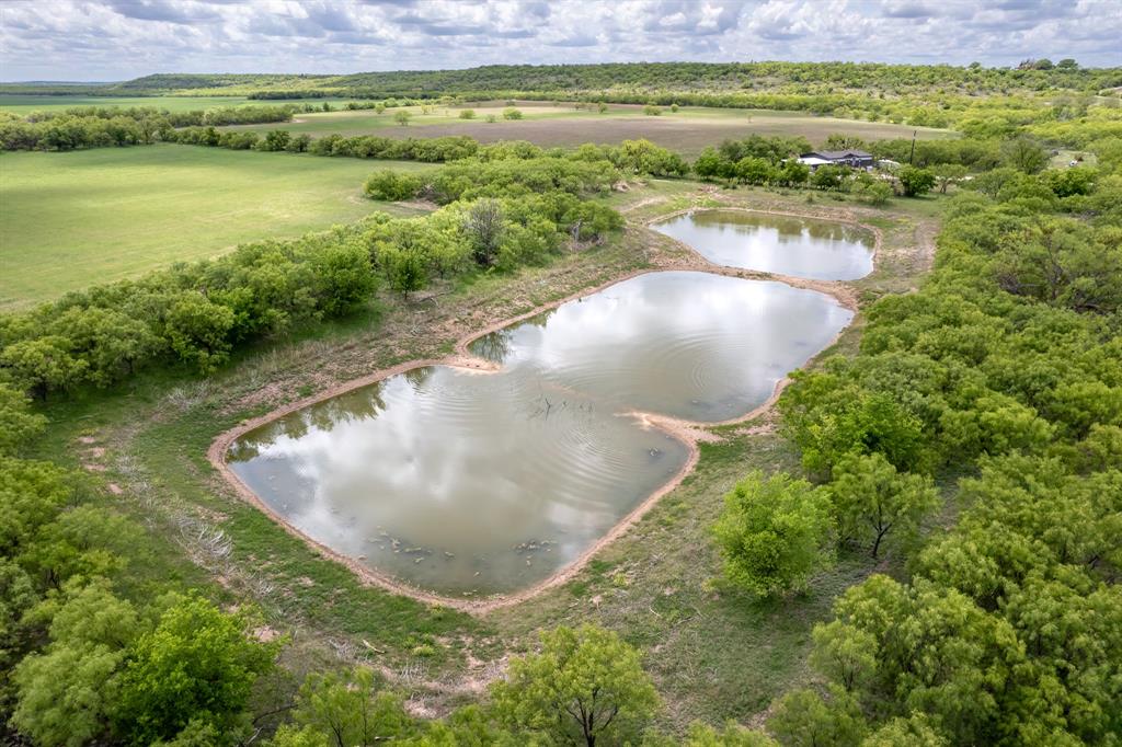 Tbd Memory Lake Road Coleman, TX 76834 - Photo 2 of 38 a view of a lake with a yard and mountain view