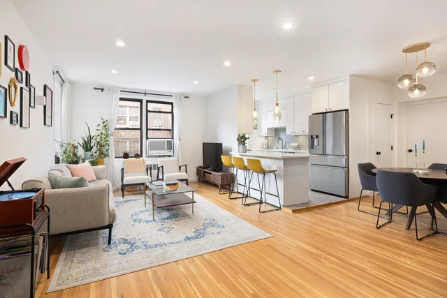 a living room with stainless steel appliances kitchen island granite countertop furniture and a kitchen view