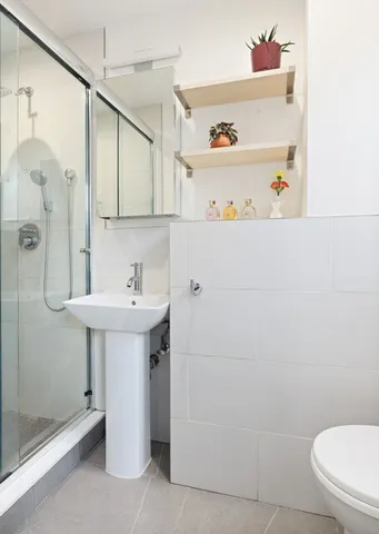 a bathroom with a sink a toilet and a shower