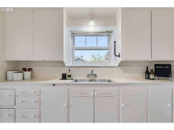 647 5th Street Springfield, OR 97477 - Photo 12 of 40 a kitchen with a sink dishwasher a stove and cabinets