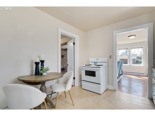 647 5th Street Springfield, OR 97477 - Photo 14 of 40 a kitchen with stainless steel appliances kitchen island granite countertop a stove a sink and a microwave