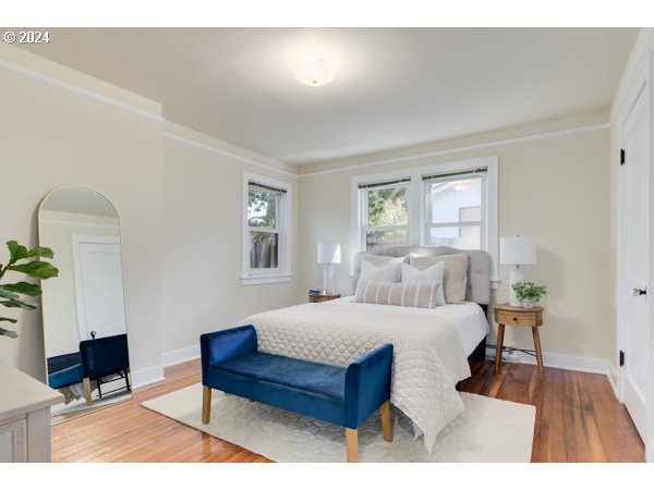 647 5th Street Springfield, OR 97477 - Photo 17 of 40 a bedroom with a bed a potted plant on dresser and a window
