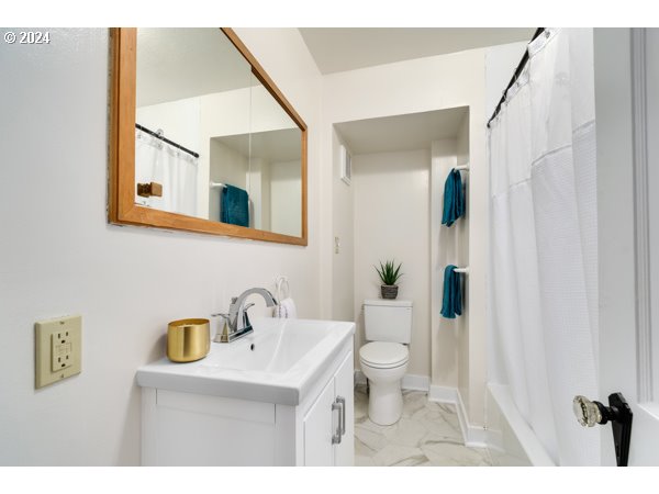 647 5th Street Springfield, OR 97477 - Photo 19 of 40 a bathroom with a sink a toilet and mirror