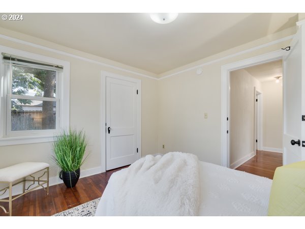 647 5th Street Springfield, OR 97477 - Photo 23 of 40 a bedroom with a bed and a potted plant