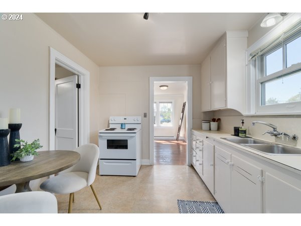 647 5th Street Springfield, OR 97477 - Photo 10 of 40 a kitchen with a stove a sink and a refrigerator
