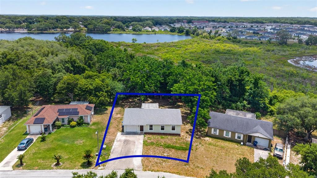 36 Bay Ridge Loop Mascotte, FL 34753 - Photo 4 of 32 an aerial view of residential houses with outdoor space and river