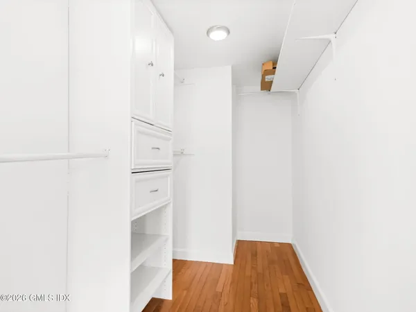 a view of walk in closet with empty racks