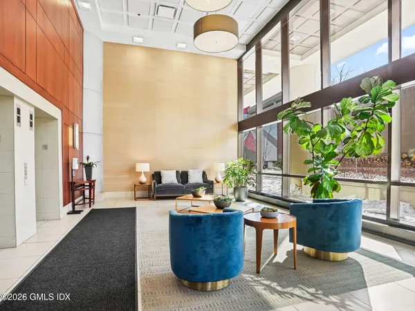 a living room with couches a coffee table and a potted plant