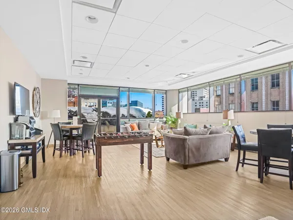 a living room with furniture and wooden floor