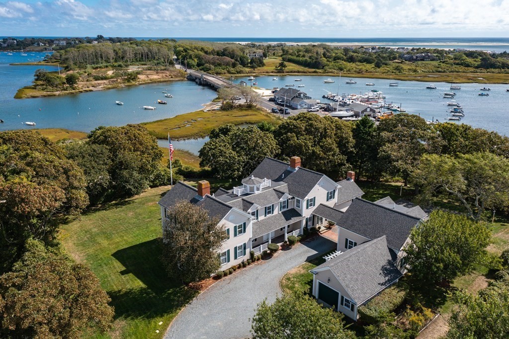 513 Stage Harbor Road Chatham, MA 02633 - Photo 1 of 42 an aerial view of a house with a garden