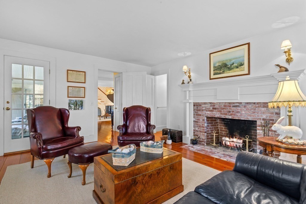 513 Stage Harbor Road Chatham, MA 02633 - Photo 13 of 42 a living room with furniture and a fireplace