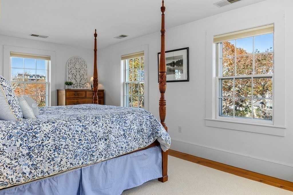 513 Stage Harbor Road Chatham, MA 02633 - Photo 25 of 42 a bedroom with a bed and a dresser next to a window