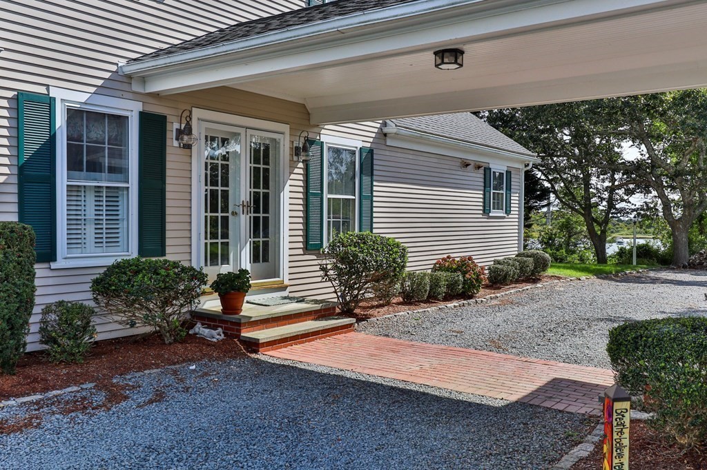 513 Stage Harbor Road Chatham, MA 02633 - Photo 33 of 42 a front view of a house with garden
