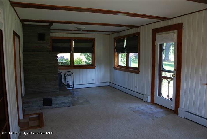 490 Orange Road Dallas, PA 18612 - Photo 7 of 29 an empty room that has a wooden floor and windows