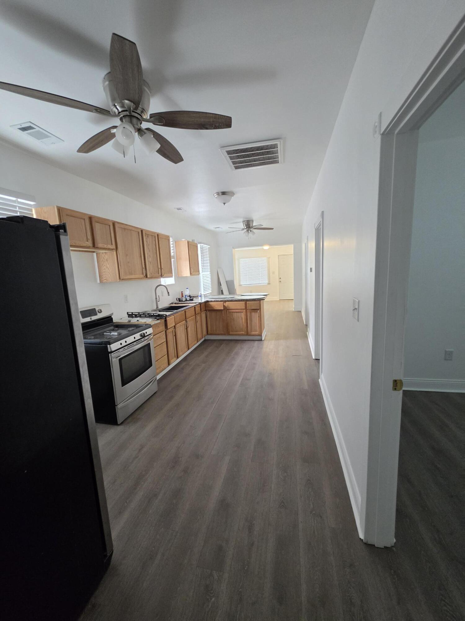 4149 Broadway Gary, IN 46409 - Photo 11 of 26 a view of a kitchen with a sink wooden floor and window