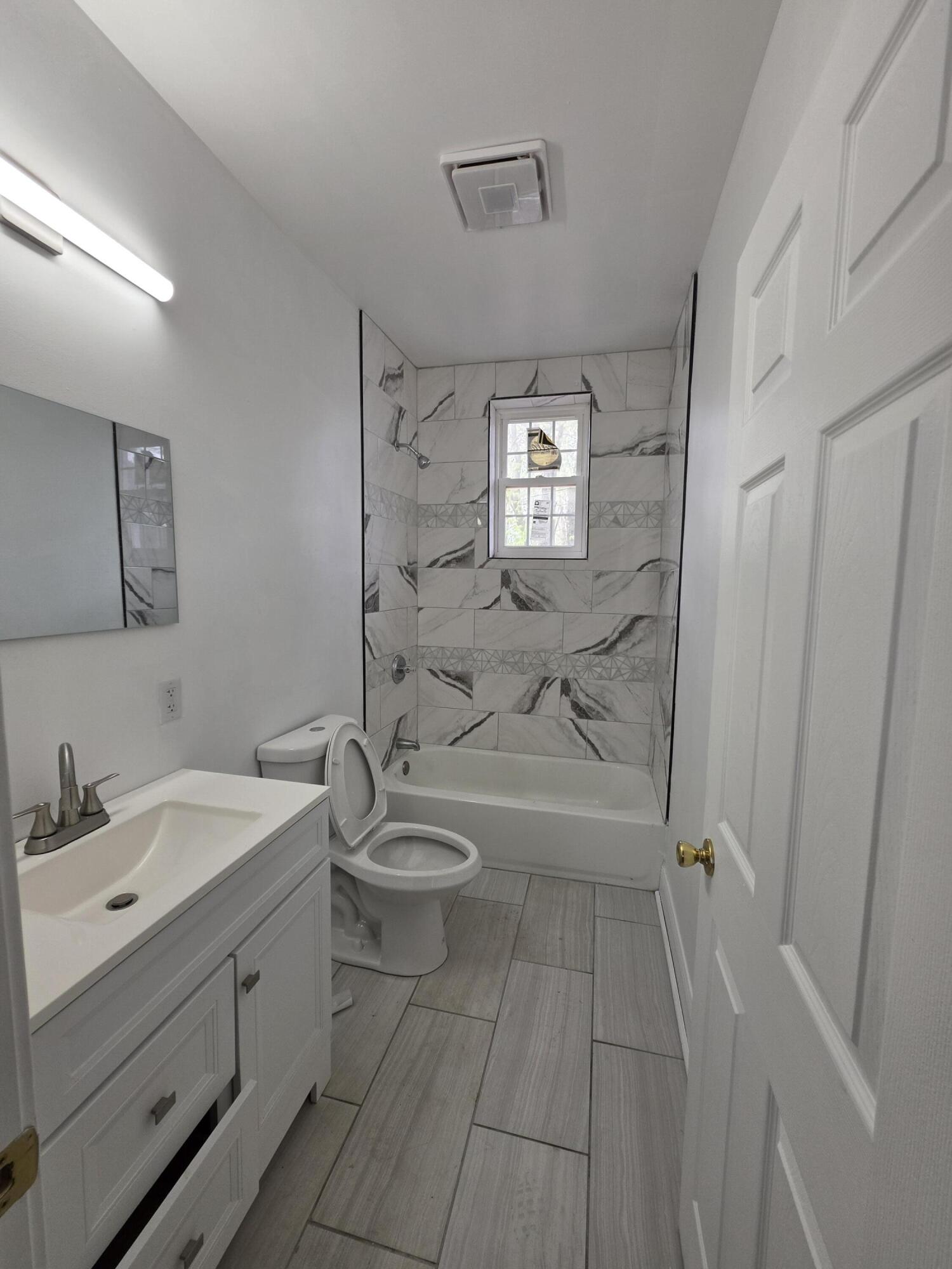 4149 Broadway Gary, IN 46409 - Photo 12 of 26 a bathroom with a sink a toilet and shower